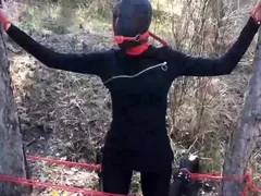 tied to a tree,  rammed in her throat