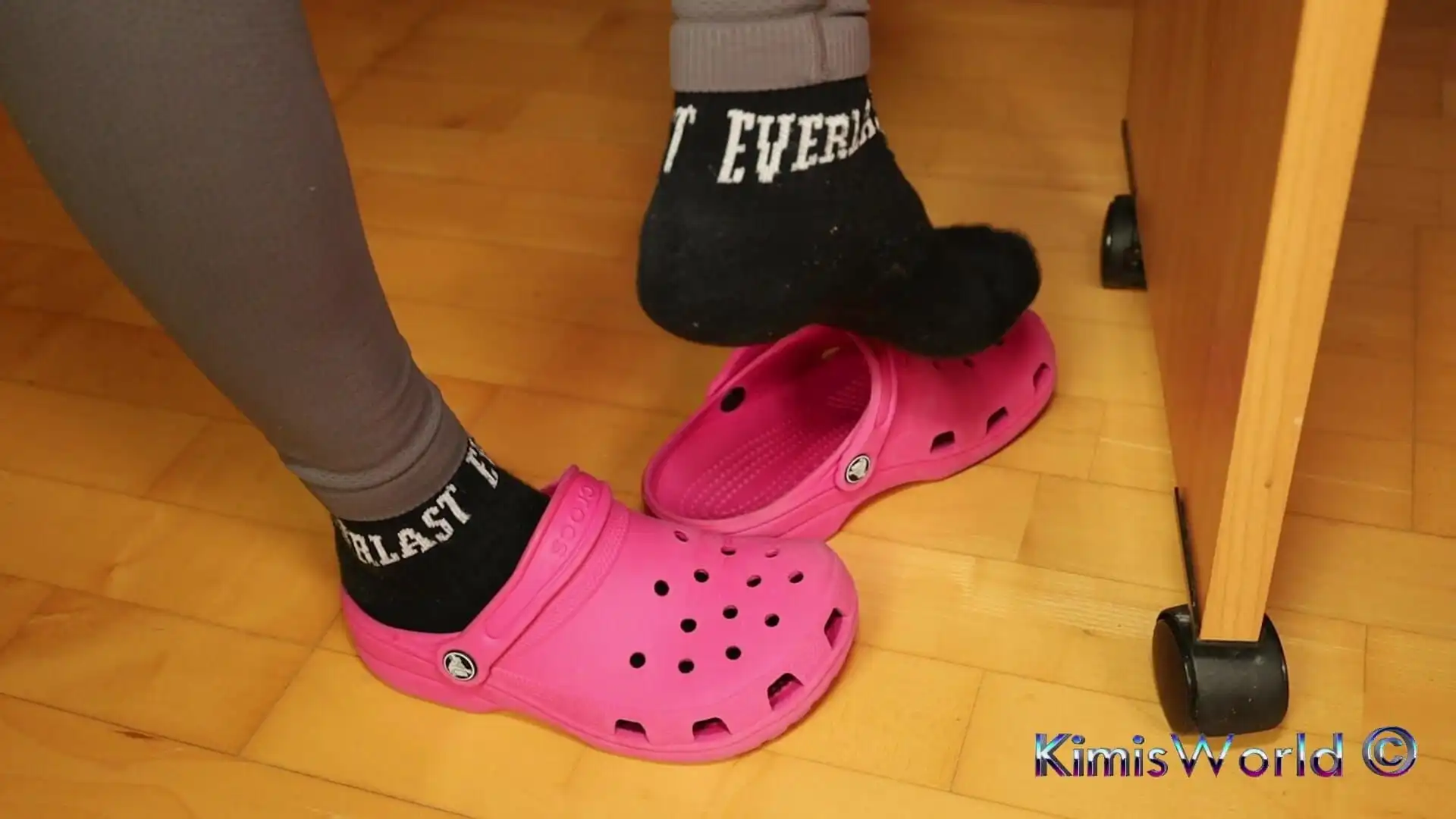 Under Desk Foot Play - Pink Clogs and Worn Socks