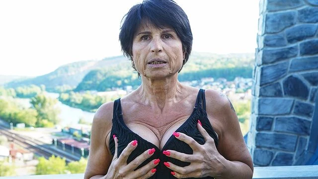 Big-boobed brunette Petra T nicely plays with her shaved pussy
